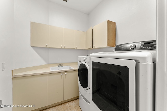 laundry room with cabinets, independent washer and dryer, light tile patterned flooring, and sink