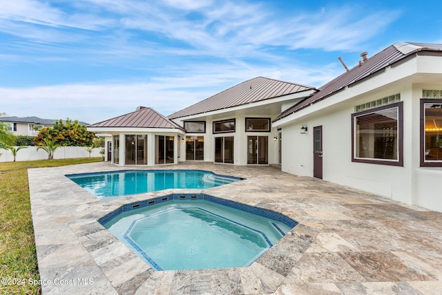 view of pool with an in ground hot tub and a patio