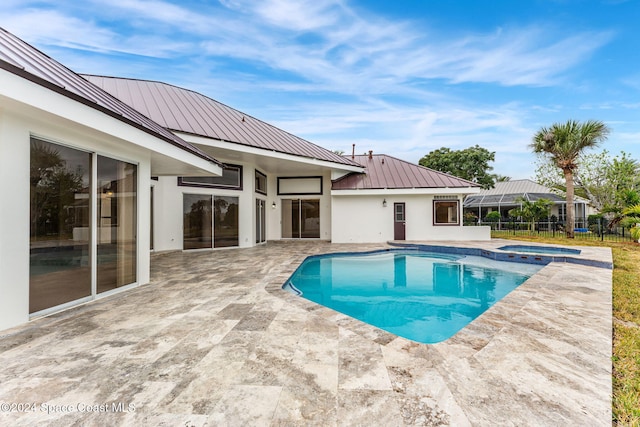 view of pool featuring an in ground hot tub and a patio