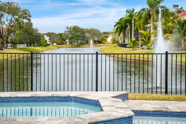 view of pool with a water view