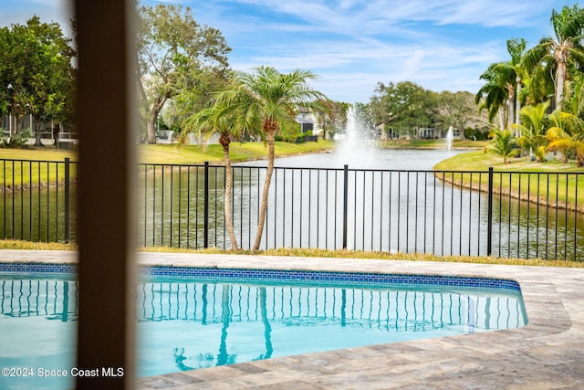 view of swimming pool with a water view