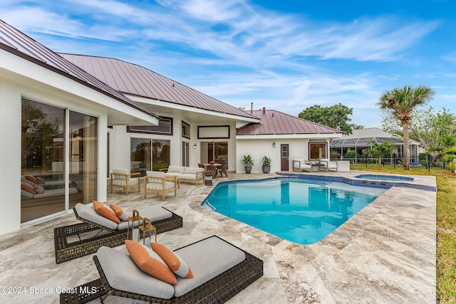 view of swimming pool featuring a patio area, an in ground hot tub, and an outdoor living space