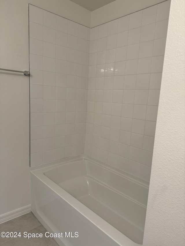 bathroom featuring tile patterned flooring and tiled shower / bath combo