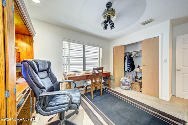 carpeted office featuring a textured ceiling