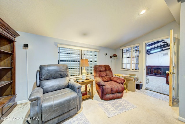 sitting room with light carpet and vaulted ceiling