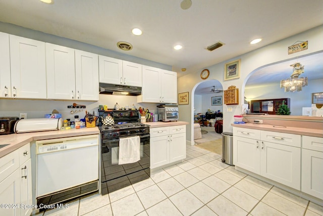 kitchen with hanging light fixtures, light tile patterned floors, black range with gas stovetop, white dishwasher, and white cabinets