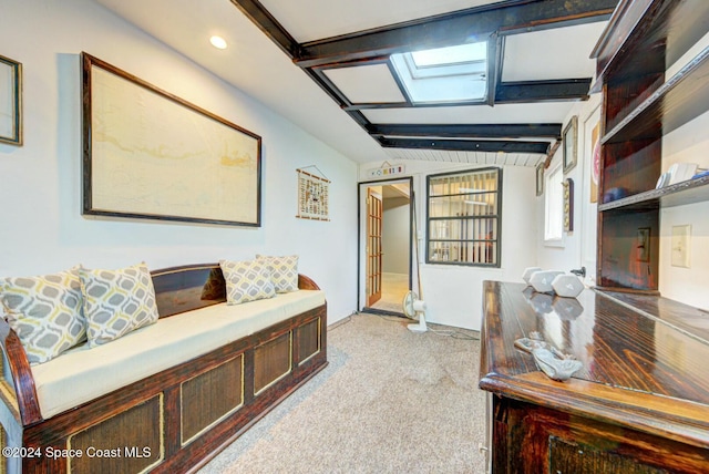 hallway with light colored carpet and lofted ceiling