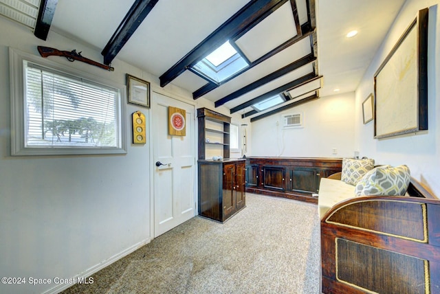 interior space with vaulted ceiling with skylight