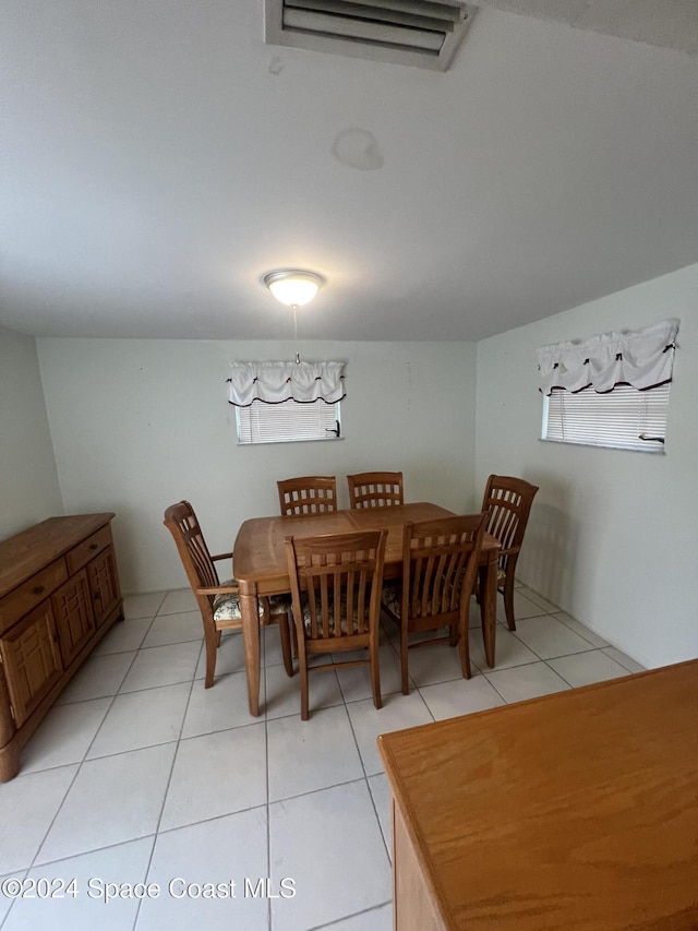 dining space featuring light tile patterned flooring