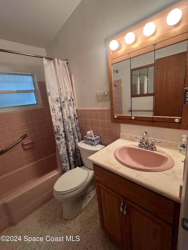 full bathroom with vanity, toilet, shower / bath combination with curtain, and tile walls