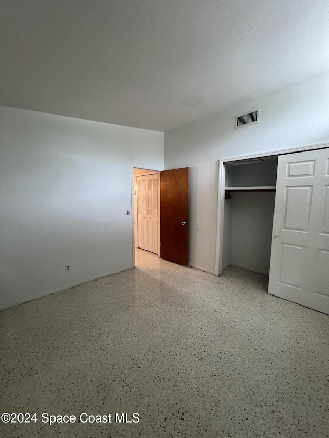 unfurnished bedroom with a closet