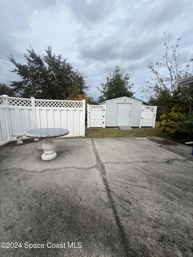 view of patio / terrace featuring a storage unit