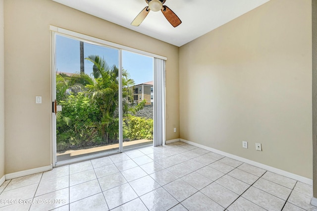 tiled spare room featuring ceiling fan