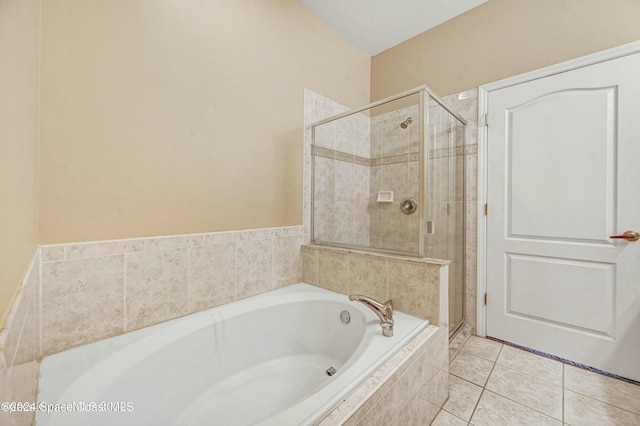 bathroom featuring tile patterned floors and shower with separate bathtub