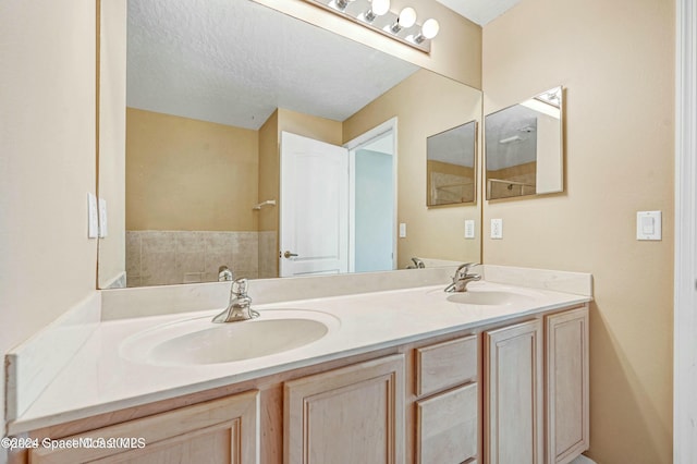 bathroom with vanity and a textured ceiling