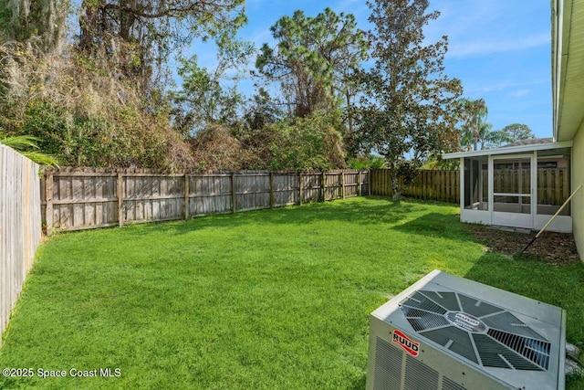 view of yard featuring a sunroom and central AC