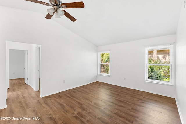 empty room with high vaulted ceiling and wood-type flooring