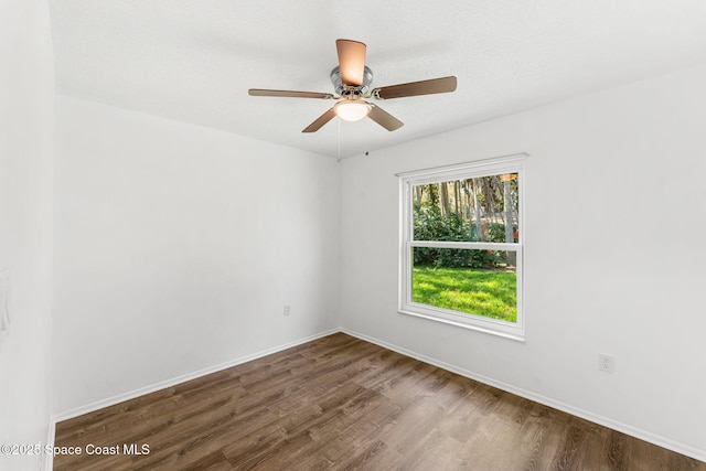 empty room with ceiling fan and wood-type flooring