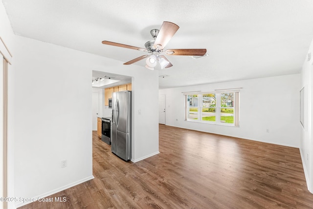 interior space with ceiling fan and hardwood / wood-style floors