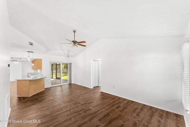 unfurnished living room featuring vaulted ceiling, ceiling fan, and dark hardwood / wood-style floors