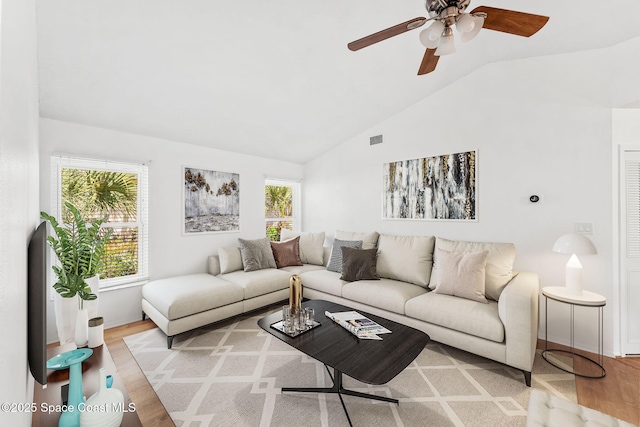 living room featuring light wood-type flooring, plenty of natural light, ceiling fan, and lofted ceiling