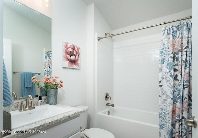 full bathroom featuring vanity, shower / bath combination with curtain, and toilet