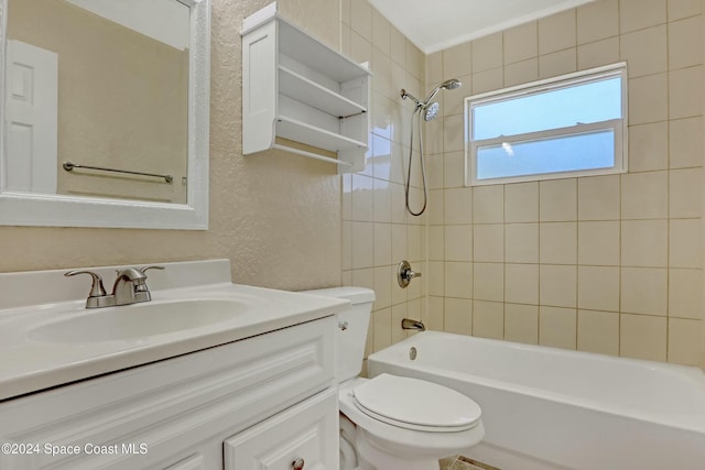 full bathroom with vanity, tiled shower / bath combo, and toilet