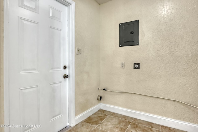 clothes washing area featuring tile patterned flooring, electric panel, and hookup for an electric dryer