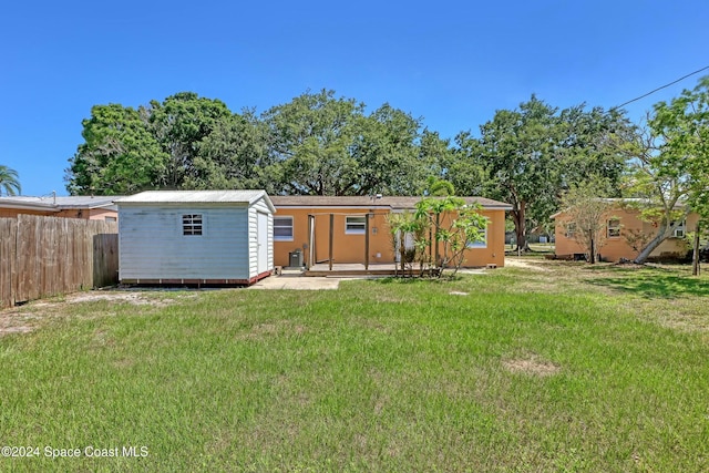 rear view of property with a yard