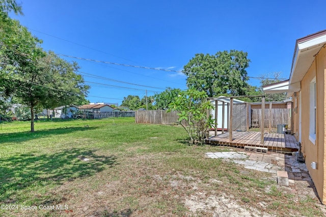 view of yard with a shed and a wooden deck