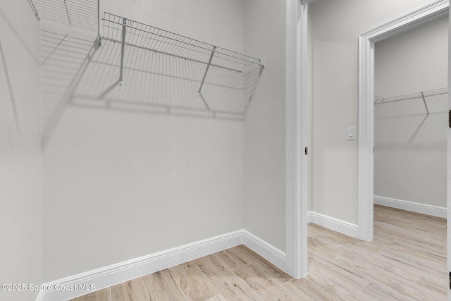 spacious closet featuring light wood-type flooring