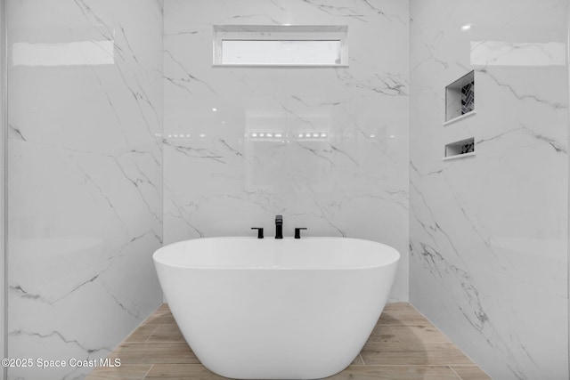 bathroom featuring a tub to relax in