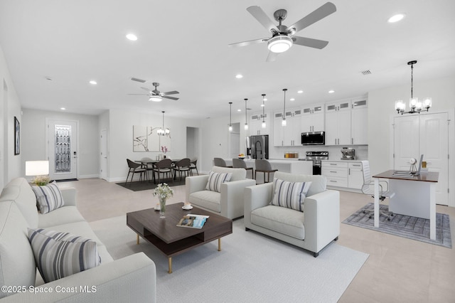 living room featuring ceiling fan with notable chandelier