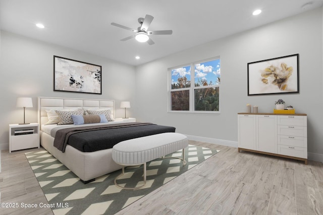 bedroom with ceiling fan and light hardwood / wood-style flooring