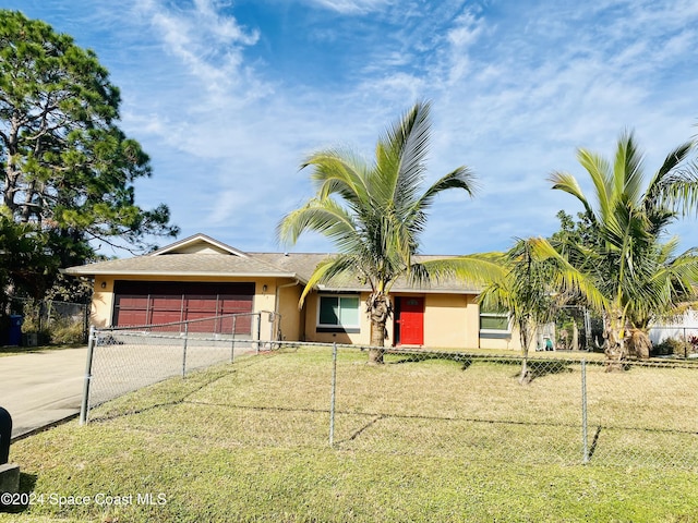 single story home featuring a garage and a front lawn