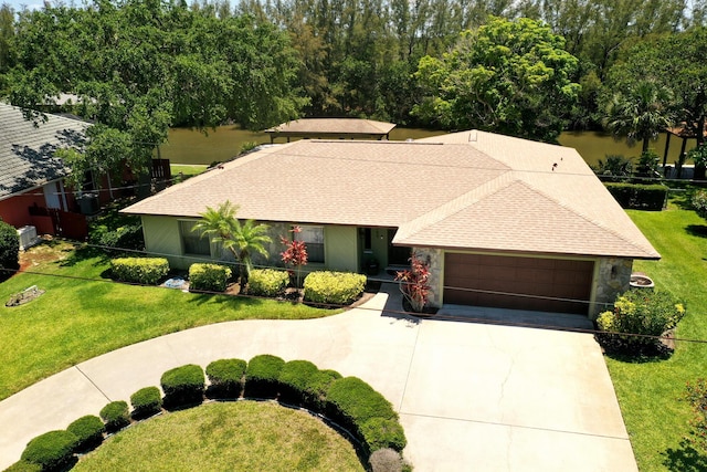 ranch-style home featuring a garage and a front lawn