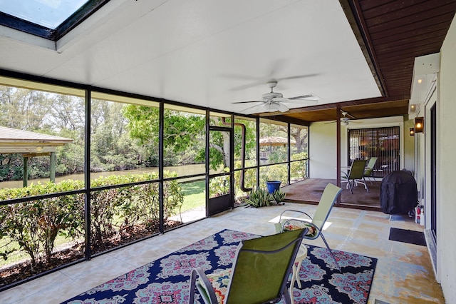 sunroom / solarium featuring a wealth of natural light and ceiling fan