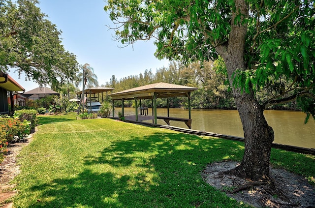 exterior space featuring a gazebo, a water view, and a yard