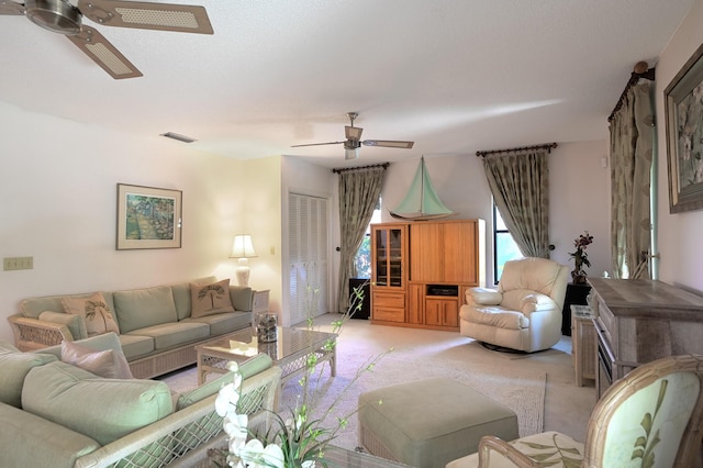 living room featuring light colored carpet and ceiling fan