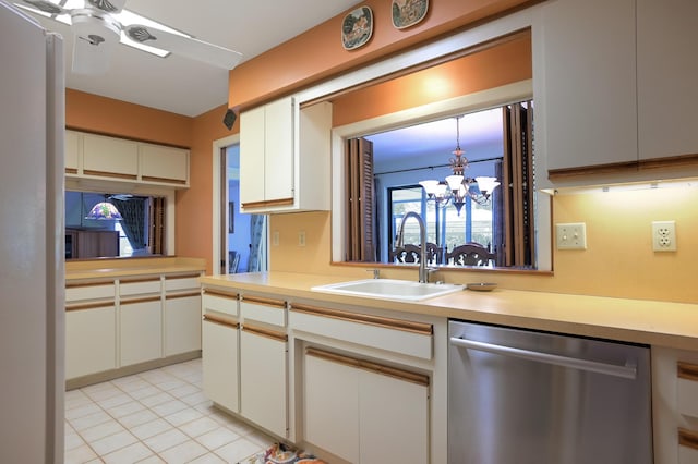 kitchen featuring stainless steel dishwasher, ceiling fan with notable chandelier, sink, white cabinets, and light tile patterned flooring