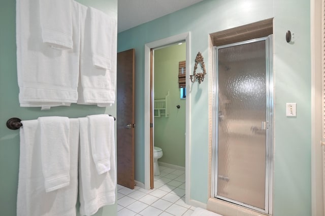 bathroom with tile patterned flooring, toilet, and walk in shower