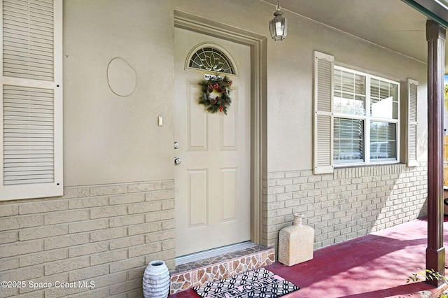 view of exterior entry featuring a porch