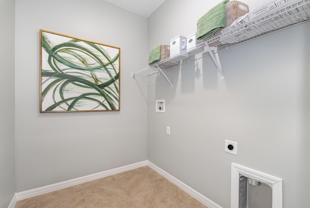 clothes washing area with hookup for an electric dryer, hookup for a washing machine, and light tile patterned flooring