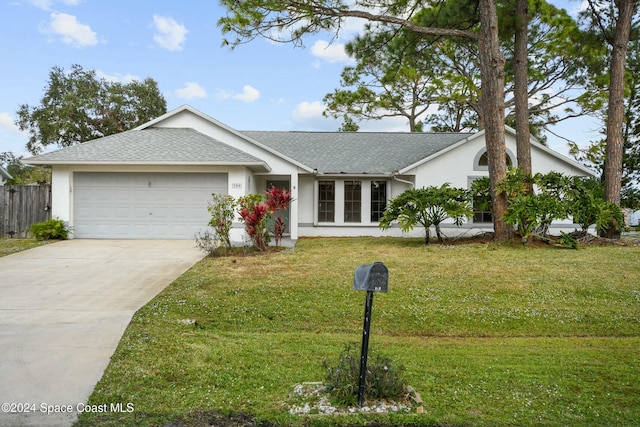 single story home with a garage and a front lawn