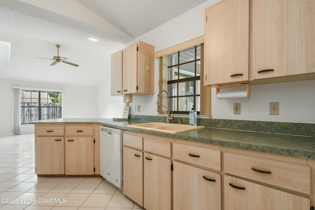 kitchen featuring dishwasher, light brown cabinets, lofted ceiling, and sink