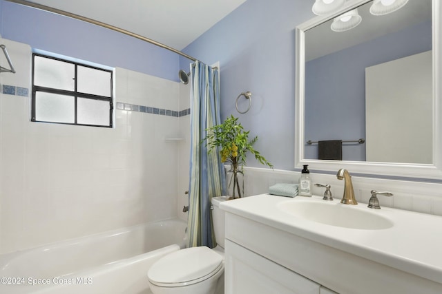 full bathroom featuring shower / bath combination with curtain, vanity, and toilet