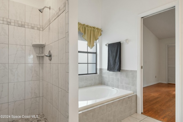 bathroom with shower with separate bathtub and hardwood / wood-style flooring