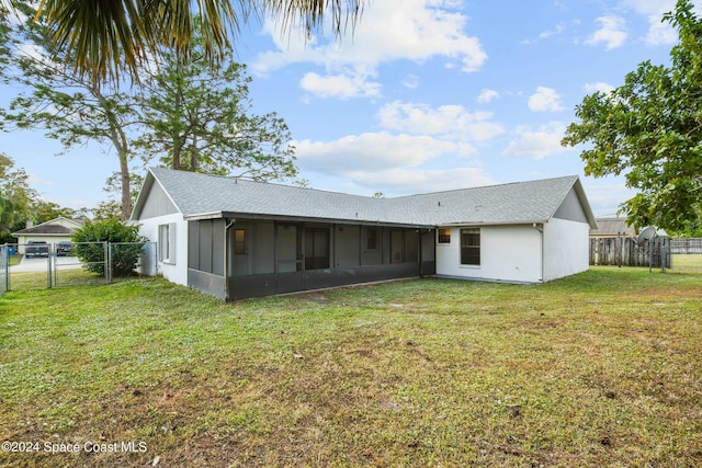 back of house featuring a sunroom and a yard