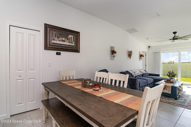 dining space featuring ceiling fan, lofted ceiling, and light tile patterned flooring