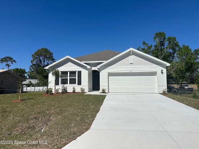 ranch-style home featuring a front yard, fence, and driveway